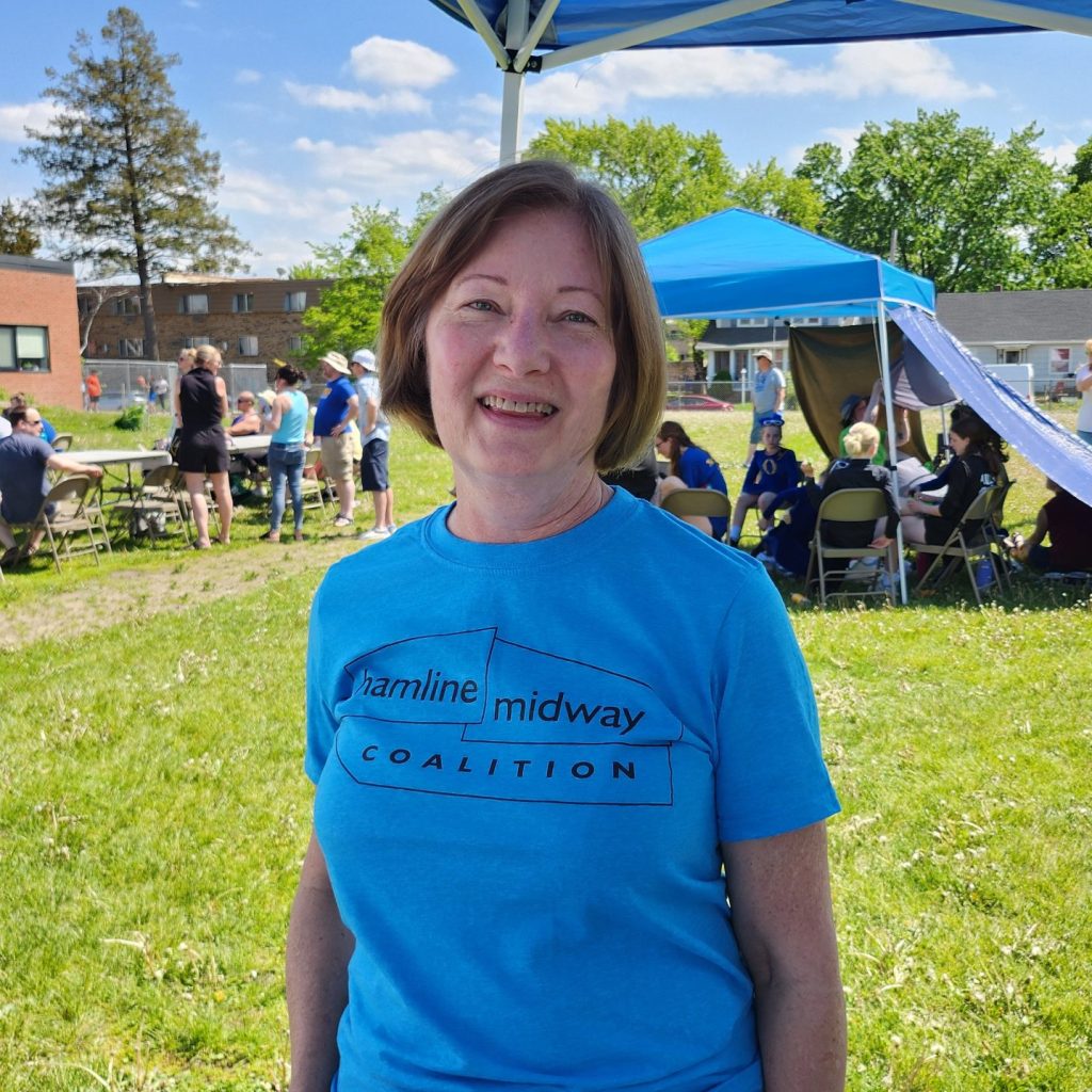 A photograph of Dawn Einwalter in an HMC volunteer shirt during a festival.